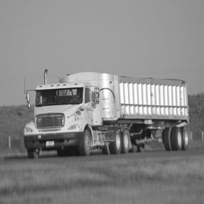 Day cab semi truck pulling a semi trailer